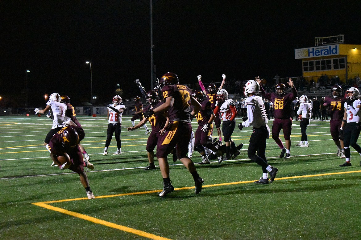 Moses Lake players celebrate as their teammate crosses into the end zone.