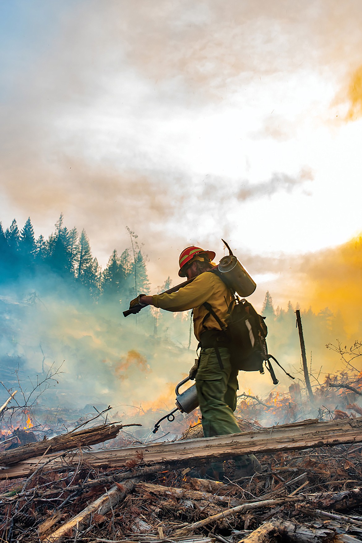 University of Idaho student Lars Filson uses a drip torch to light slash from a timber harvesting project in the university’s Experimental Forest.