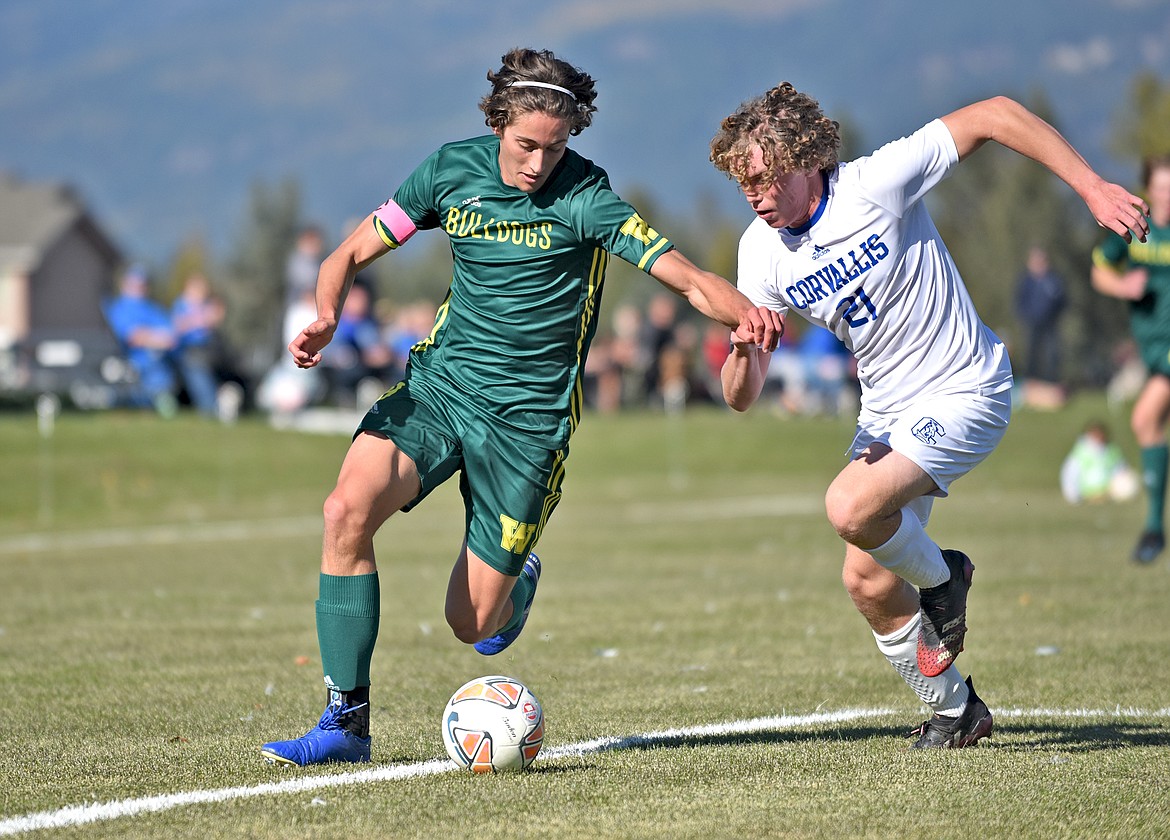 Whitefish senior Gabe Menicke works to beat a Blue Devil defender in a playoff game against Corvallis on Saturday at Smith Fields. (Whitney England/Whitefish Pilot)