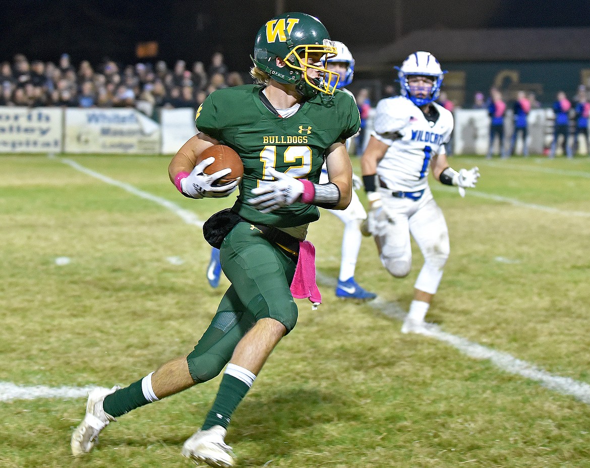 Whitefish's Logan Conklin catches a pass and looks to run the ball for more yards during a game against Columbia Falls on Friday in Whitefish. (Whitney England/Whitefish Pilot)