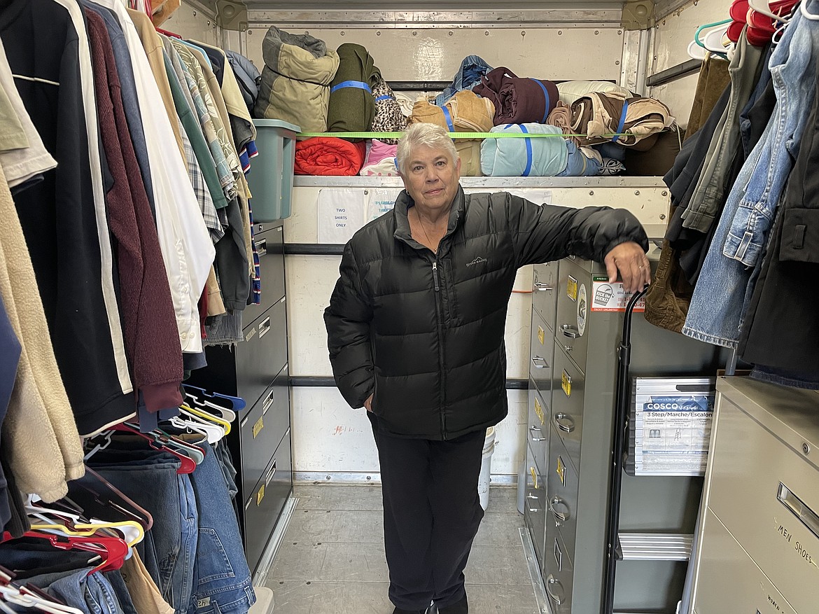 Jackie Rice stands in the back of the large truck she and husband Cal operate as part of Rice Bowl Ministries, which serves the poor and the shelterless in and around Moses Lake by giving out free clothes.