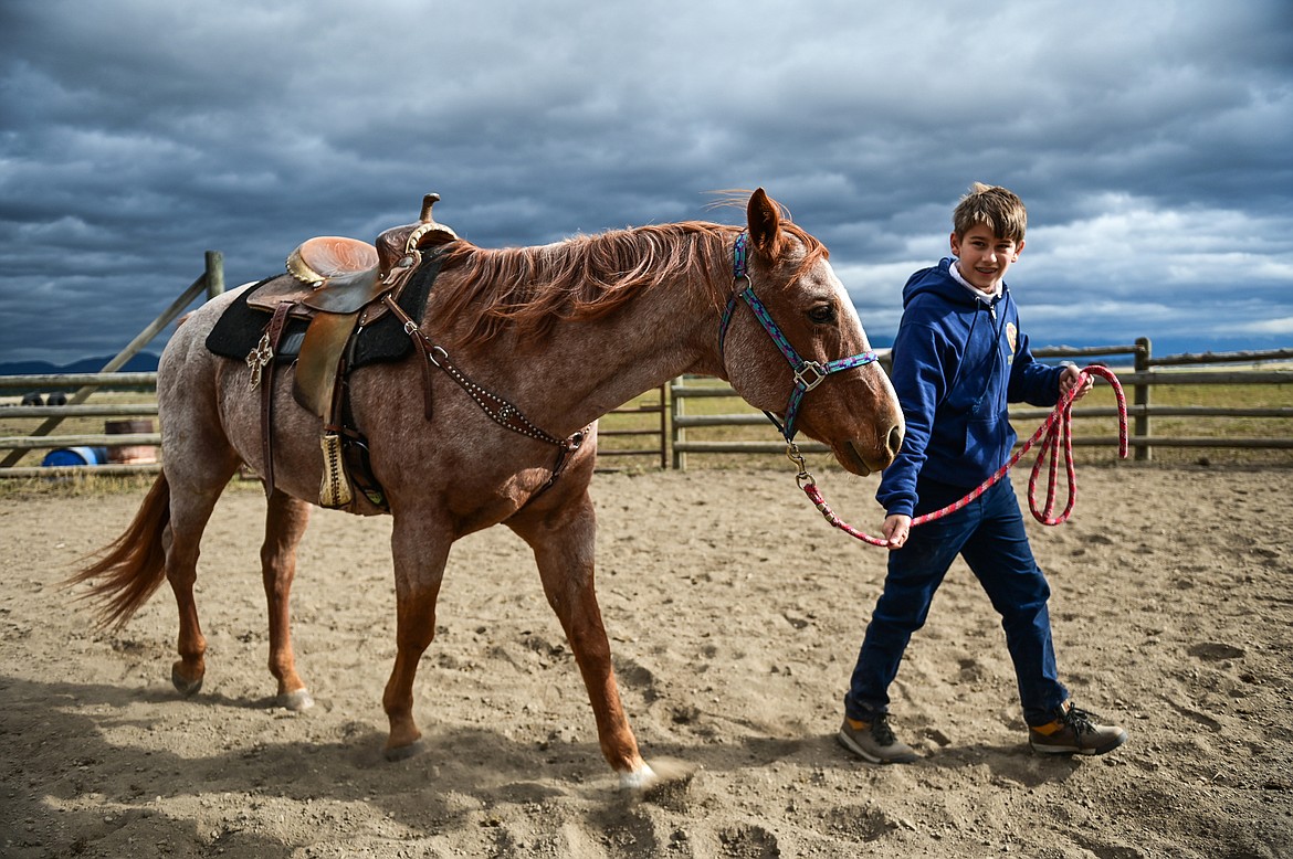 Whitefish Christian Academy seventh-grader Adrian Raci walks a horse named Hammer around the arena at Lost Creek Ranch on Friday, Oct. 15. (Casey Kreider/Daily Inter Lake)