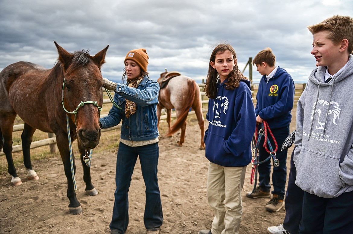 Lost Creek Ranch instructor and owner Chanel Olson shows seventh-grade students from Whitefish Christian Academy how to halter her horse named Royal on Friday, Oct. 15. (Casey Kreider/Daily Inter Lake)