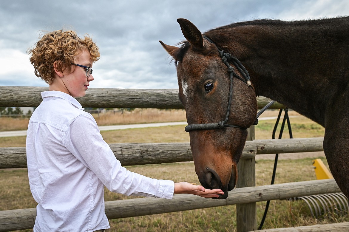 Jack Flink, a seventh-grader from Whitefish Christian Academy, feeds a horse named Leo a treat at Lost Creek Ranch on Friday, Oct. 15. (Casey Kreider/Daily Inter Lake)