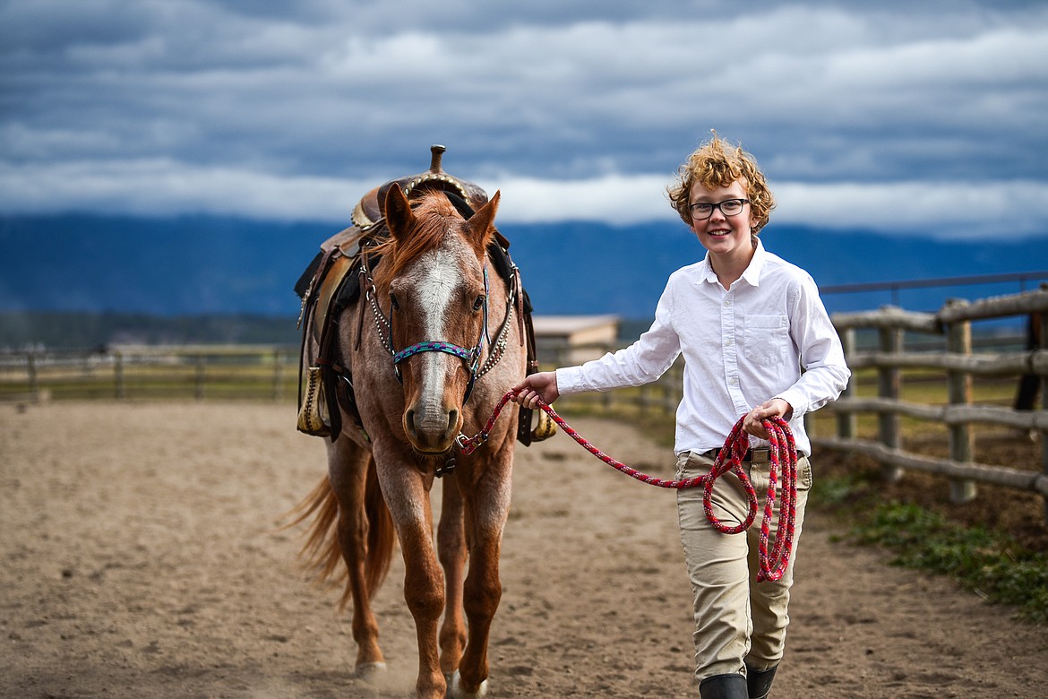Jack Flink, a seventh-grader from Whitefish Christian Academy, leads a horse named Hammer around the arena at Lost Creek Ranch on Friday, Oct. 15. (Casey Kreider/Daily Inter Lake)