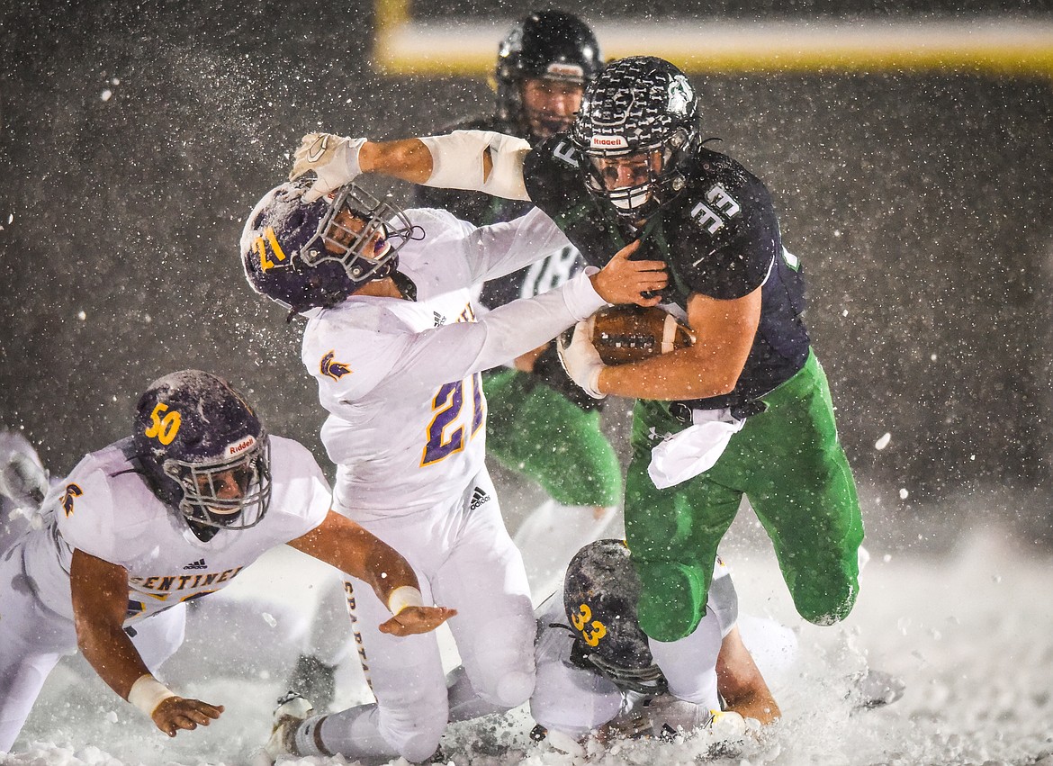 Glacier running back Jake Rendina (33) extends a stiff-arm to Missoula Sentinel defender Donovan South (21) on a second quarter run at Legends Stadium on Friday, Oct. 23, 2020. (Casey Kreider/Daily Inter Lake)