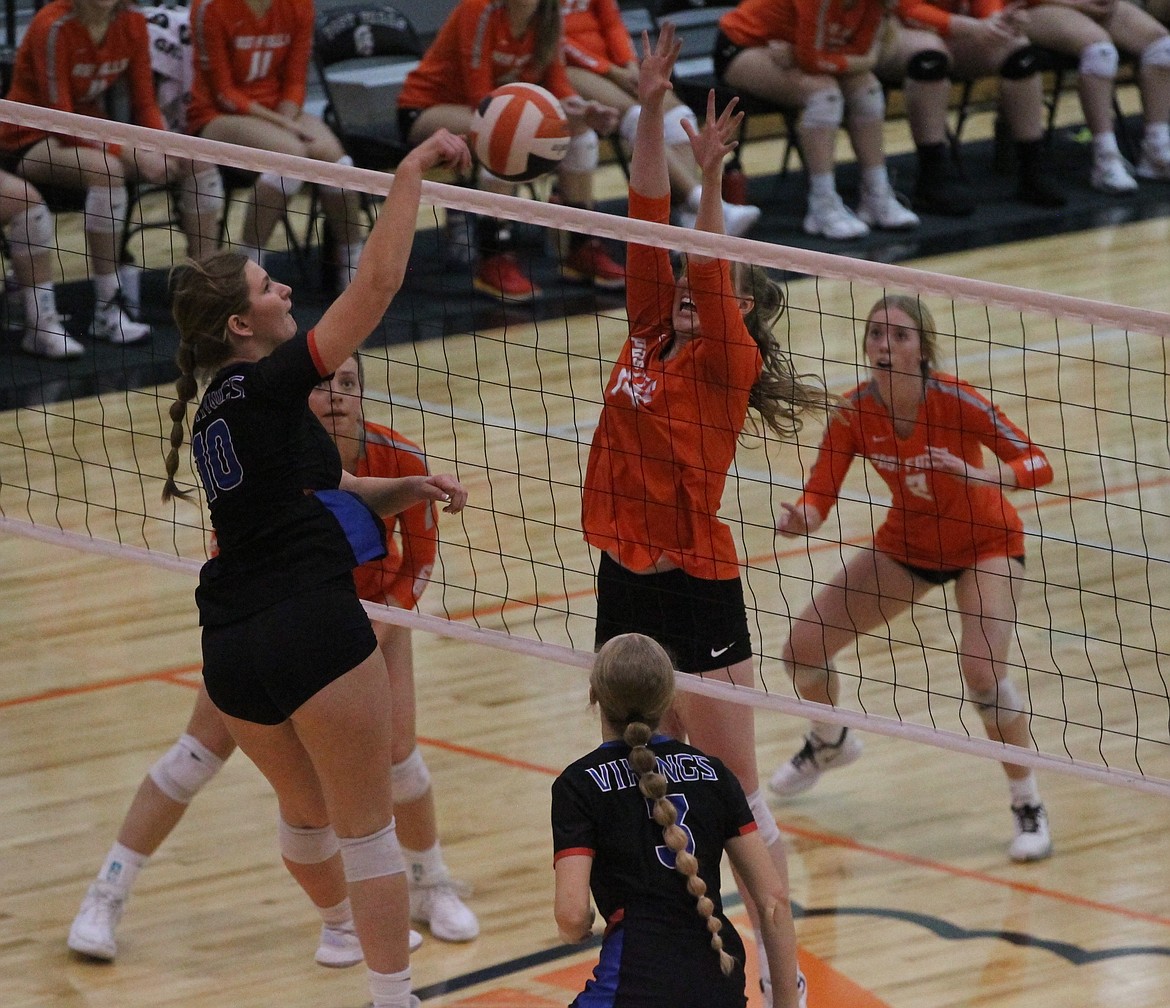 MARK NELKE/Press
Lindsay Stubbs (10) of Coeur d'Alene hits against the block of Hanna Christensen of Post Falls in the 5A Region 1 volleyball championship match Tuesday night at Post Falls.