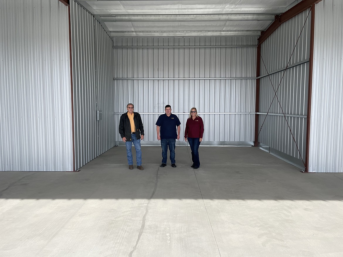 Port of Othello Commissioner Gary Weaver, executive director Chris Faix, and commissioner Deena Vietzke stand inside one of the new hangar bays at the Othello Municipal Airport.