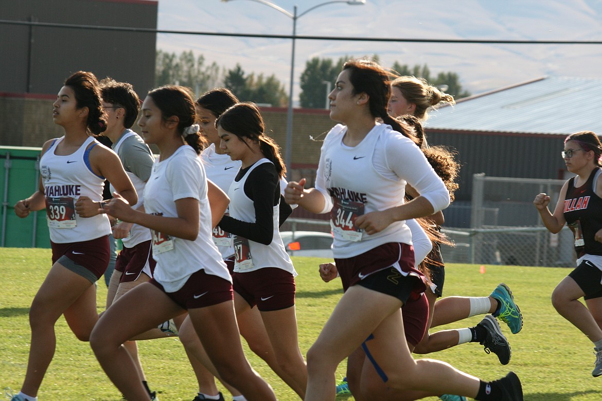 The Wahluke High School girls cross-country team takes off from the start line at the meet at WHS Thursday.