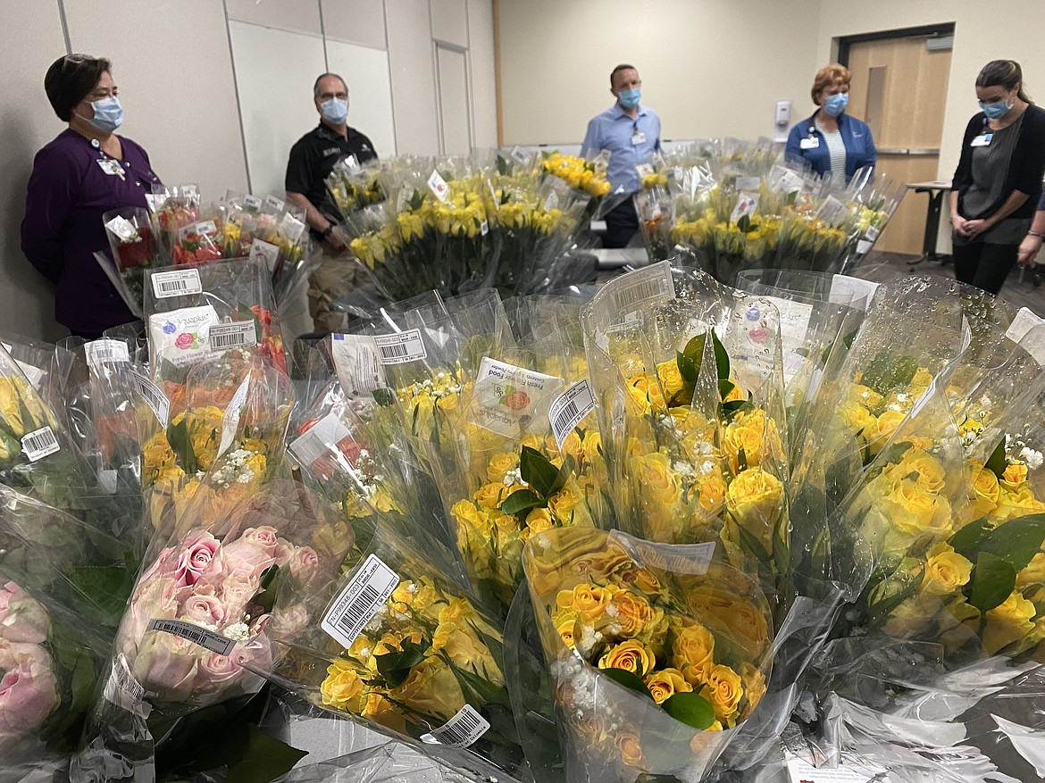 Rotary roses wait for Kootenai Health staff members eager to collect and deliver to hospital departments Tuesday.