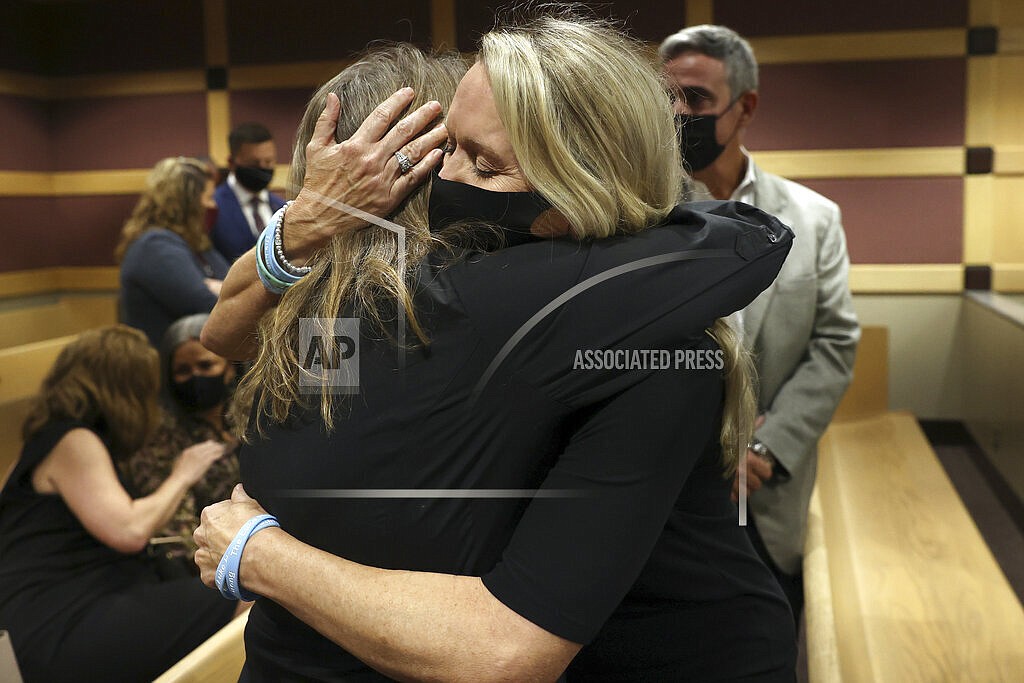 Gena Hoyer, right, hugs Debbi Hixon during a court recess following Marjory Stoneman Douglas High School shooter Nikolas Cruz's guilty plea on all 17 counts of premeditated murder and 17 counts of attempted murder in the 2018 shootings, Wednesday, Oct. 20, 2021, at the Broward County Courthouse in Fort Lauderdale, Fla. Hoyer's son, Luke Hoyer, 15, and Hixon's husband, Christopher Hixon, 49, were both killed in the massacre. (Amy Beth Bennett/South Florida Sun Sentinel via AP, Pool)