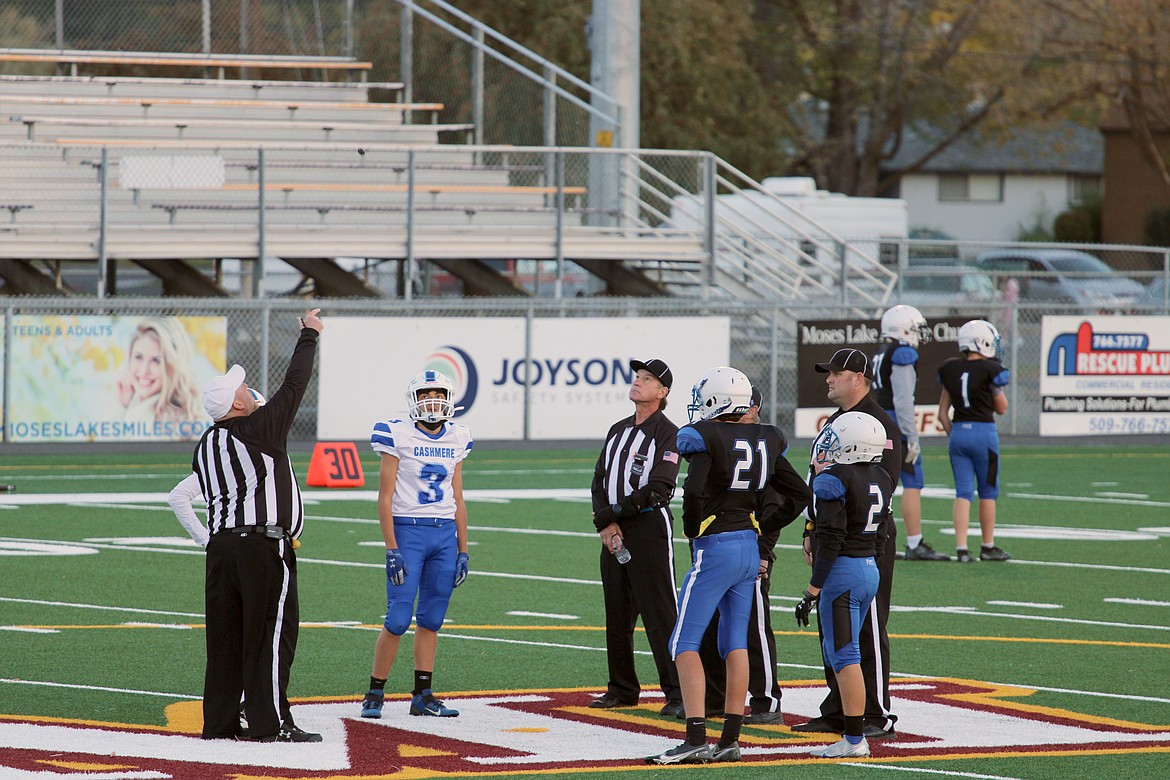 COIN TOSS: Football players from Frontier Middle School and Cashmere and referees meet with referees at midfield to start a game at Lions Field in Moses Lake recently. The proposed levy on the ballot would fund school programs including athletics and music.