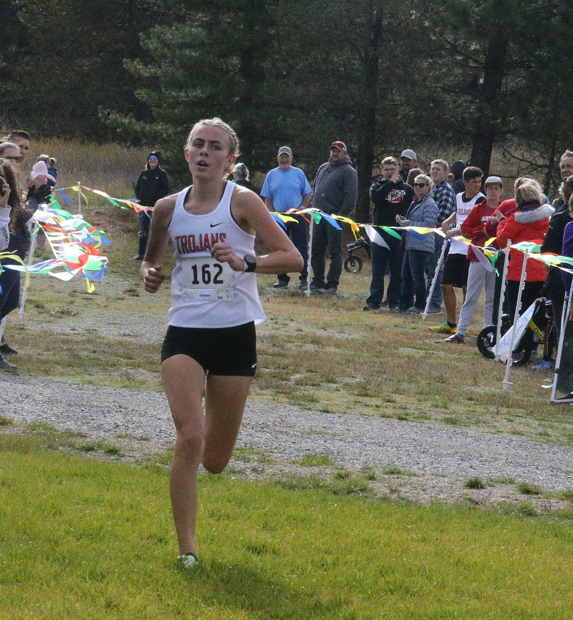 JASON ELLIOTT/Press
Post Falls junior Annastasia Peters runs to the finish line of Thursday's 5A Region 1 meet at Farragut State Park. Peters won in 18 minutes, 15.1 seconds to lead the Trojans to a runner-up finish.