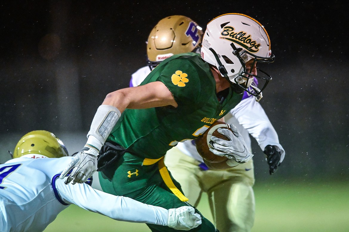 Whitefish wide receiver Bodie Smith (2) is brought down by Polson defensive back Dumont Dawson (21) after a reception in the first quarter at Memorial Field in Whitefish on Friday, Oct. 22. (Casey Kreider/Daily Inter Lake)