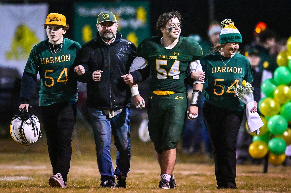 Whitefish senior linebacker Tanner Harmon (54) walks with his family during Senior Night against Polson at Memorial Field in Whitefish on Friday, Oct. 22. (Casey Kreider/Daily Inter Lake)