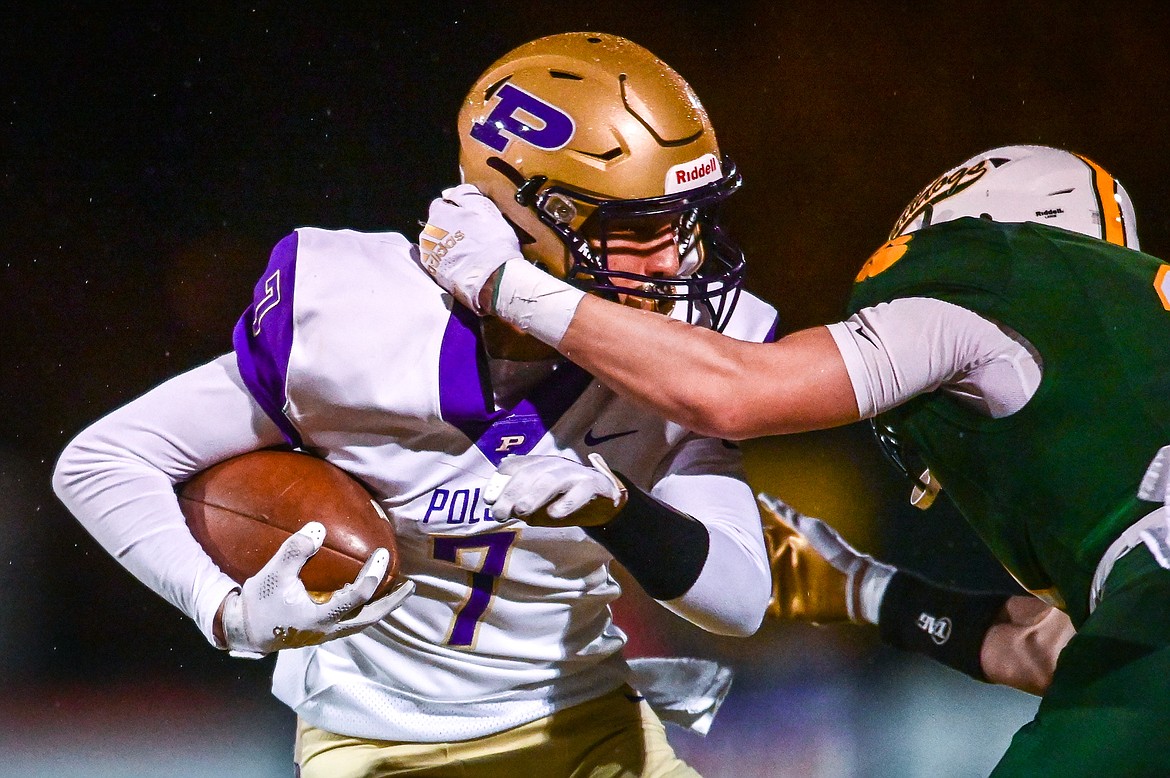 Polson wide receiver Alex Muzquiz (7) is brought down by Whitefish defensive back Jack Akey (11) in the second quarter at Memorial Field in Whitefish on Friday, Oct. 22. (Casey Kreider/Daily Inter Lake)