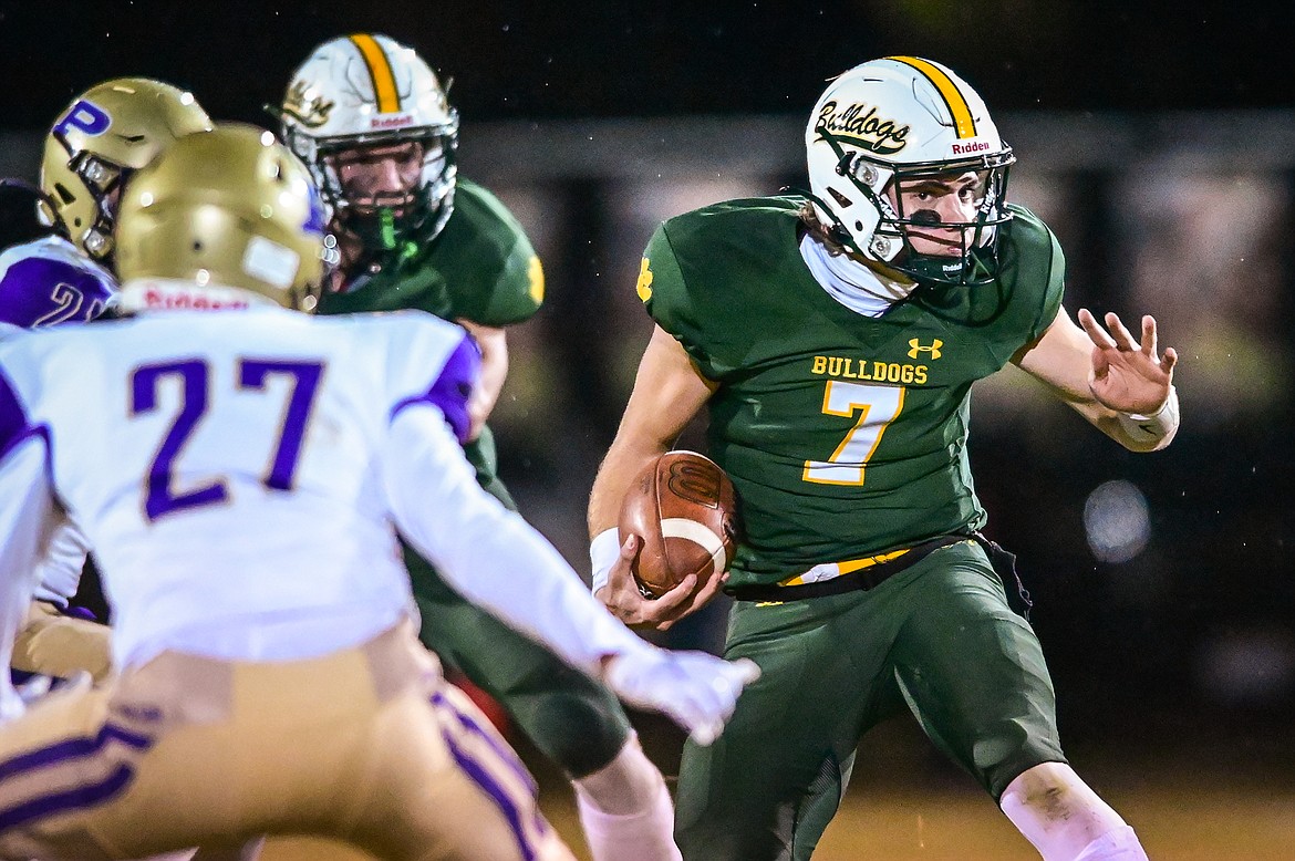 Whitefish quarterback Fynn Ridgeway (7) jukes as he picks up yardage on a run in the second quarter against Polson at Memorial Field in Whitefish on Friday, Oct. 22. (Casey Kreider/Daily Inter Lake)