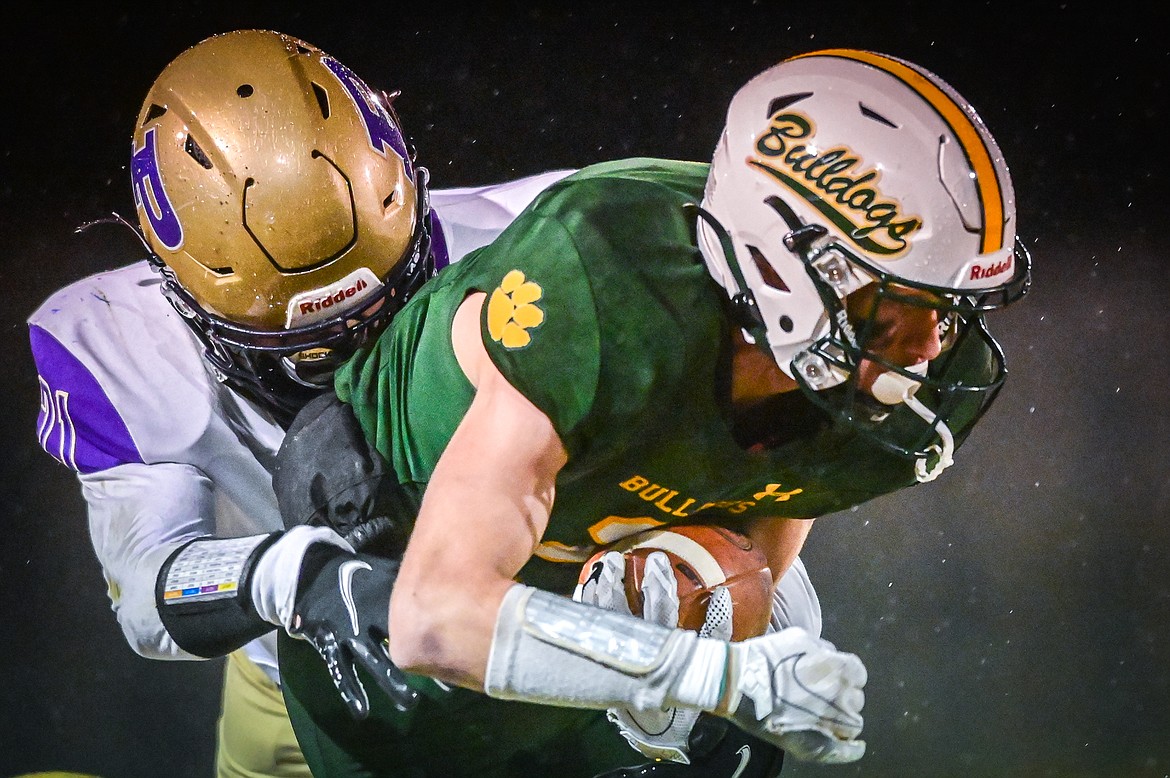 Whitefish wide receiver Bodie Smith (2) is brought down by Polson defensive back Dumont Dawson (21) after a reception in the first quarter at Memorial Field in Whitefish on Friday, Oct. 22. (Casey Kreider/Daily Inter Lake)