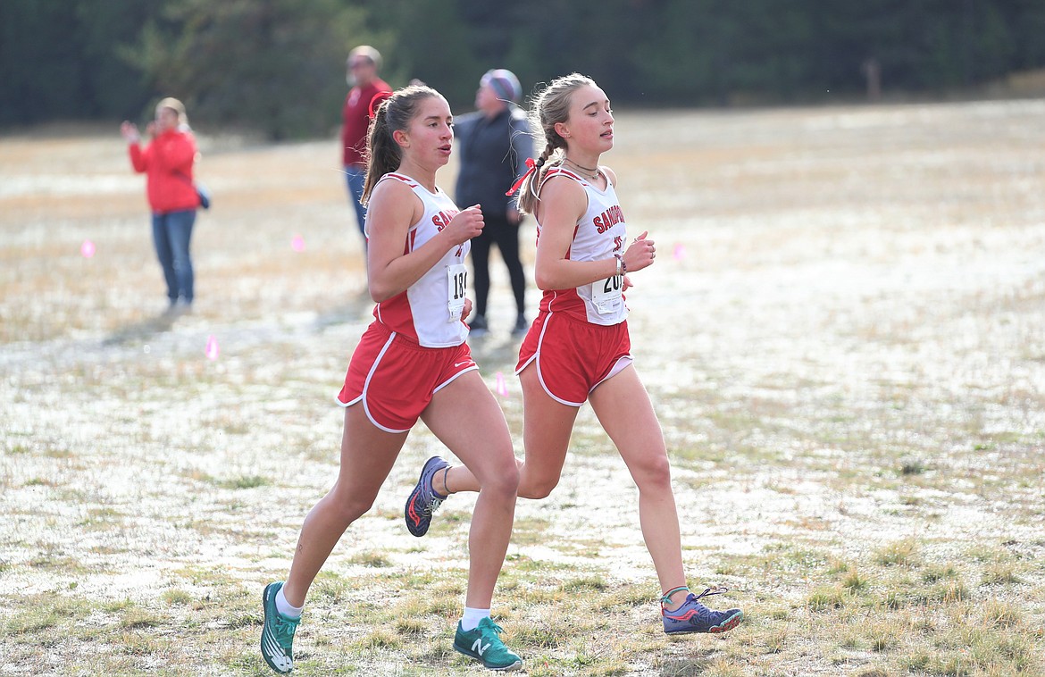 Payton Betz (left) and Grace Rookey run side-by-side on Thursday.