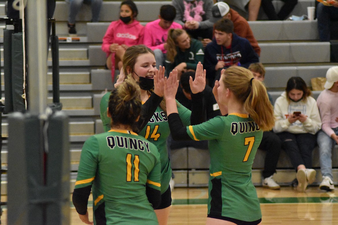 Cassidy Haille (14) high-fives teammate Shea Heikes (7) after they earned a point for the Lady Jacks.