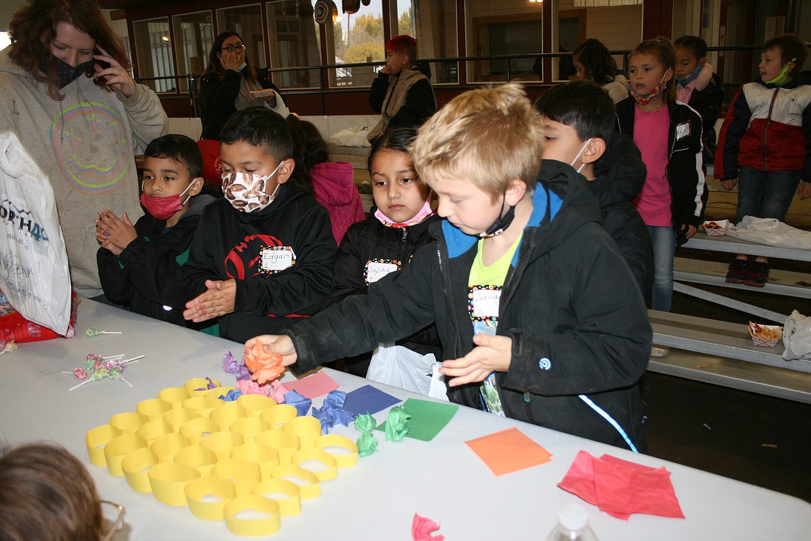 First-graders add “honey” to “honeycombs” during First Grade Farm Day Wednesday at the Grant County Fairgrounds.