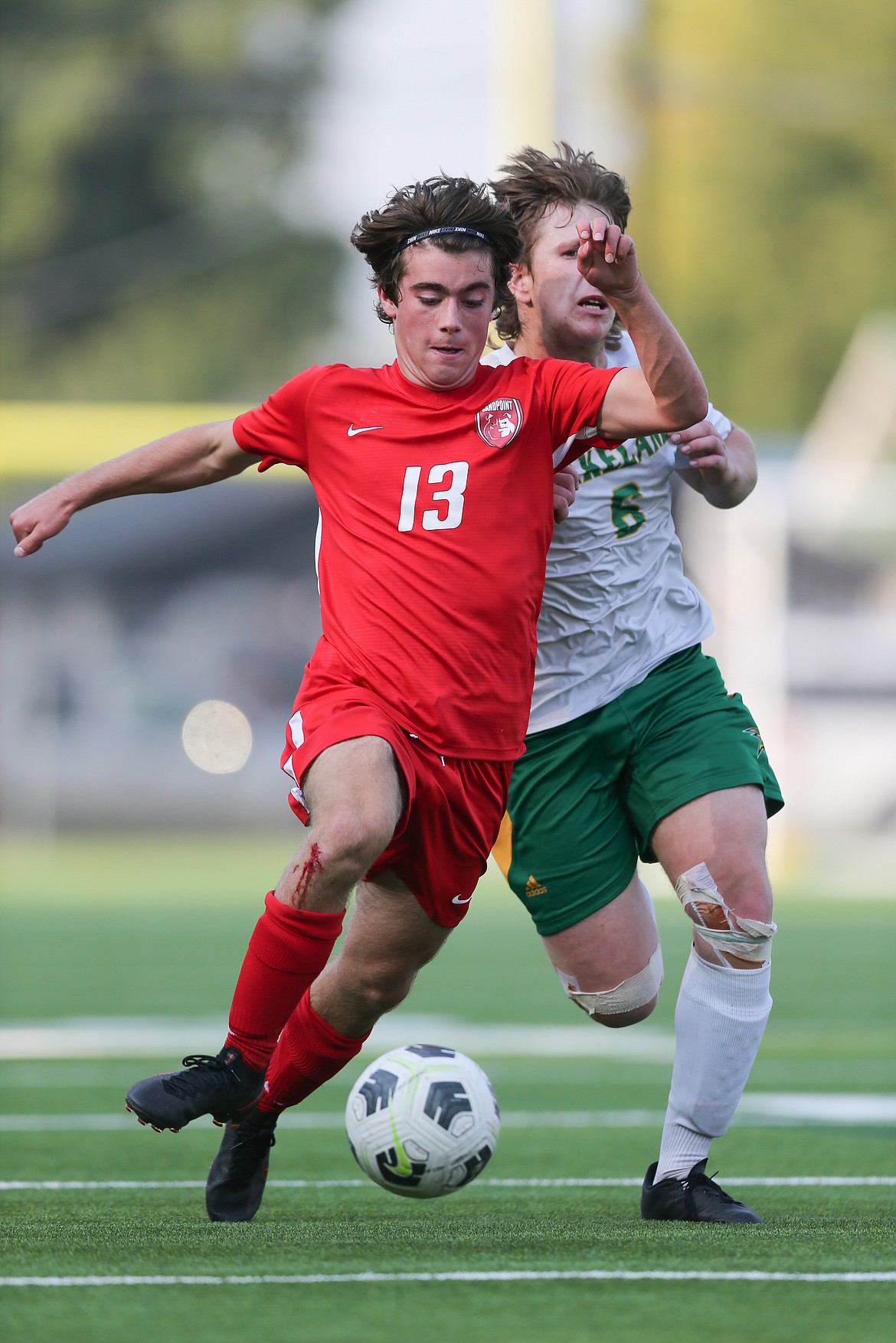 Henry Barnes dribbles the ball forward while fighting off a Lakeland defender on Sept. 8. The freshman was named Newcomer of the Year.