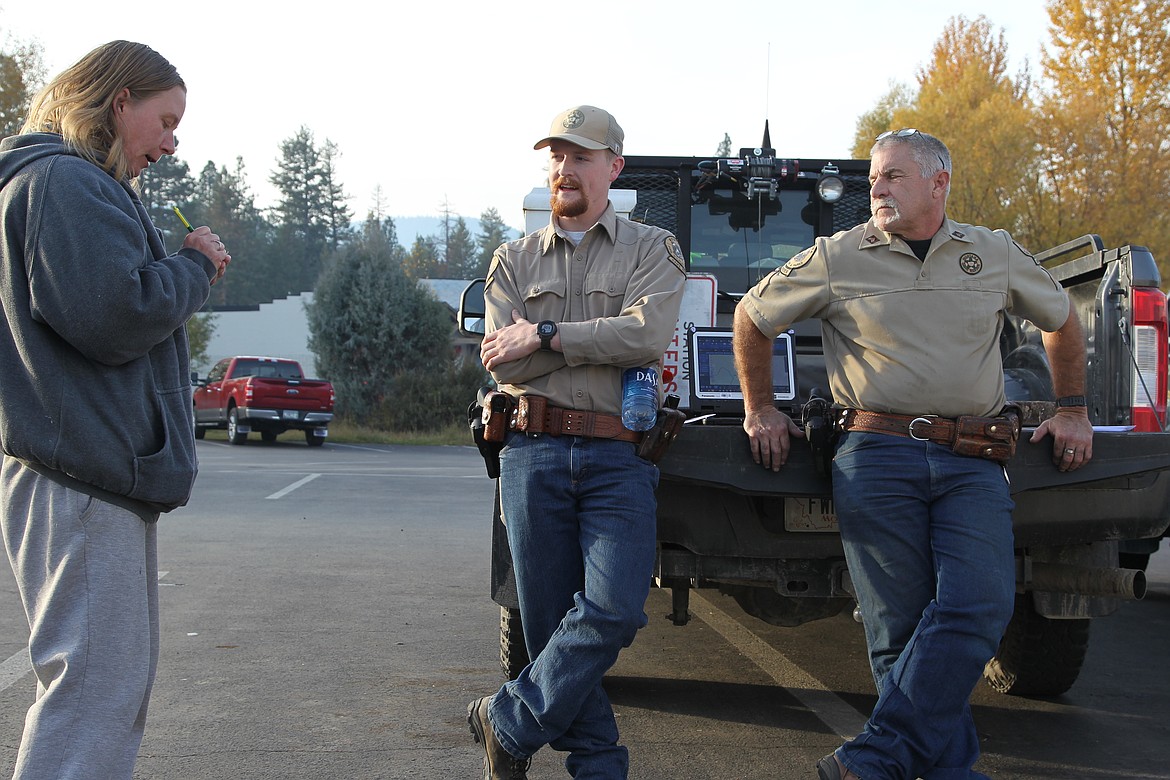 Sawyer Johnson, FWP game warden, left, and Jon Obst, FWP warden sergeant, fielded questions from hunters on the eve of the general season in the parking lot of Ace Hardware in Libby on Oct. 21. (Will Langhorne/The Wester