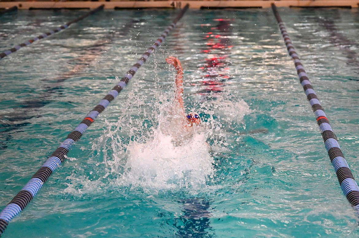 Junior Caleb Norling competes in the 100 backstroke on Friday.