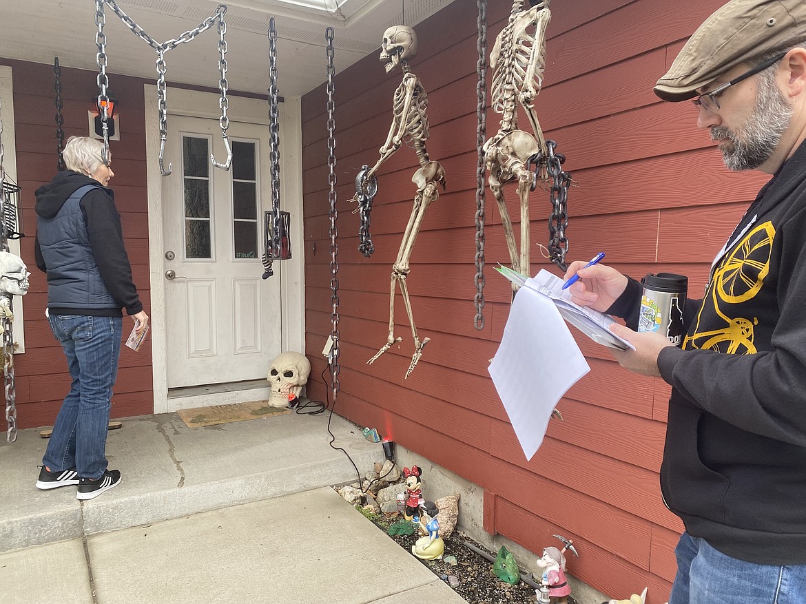 Karen and Jason Lauritzen stand outside a residence Saturday, ready to spread the word about trusted school board and fire commission candidates.