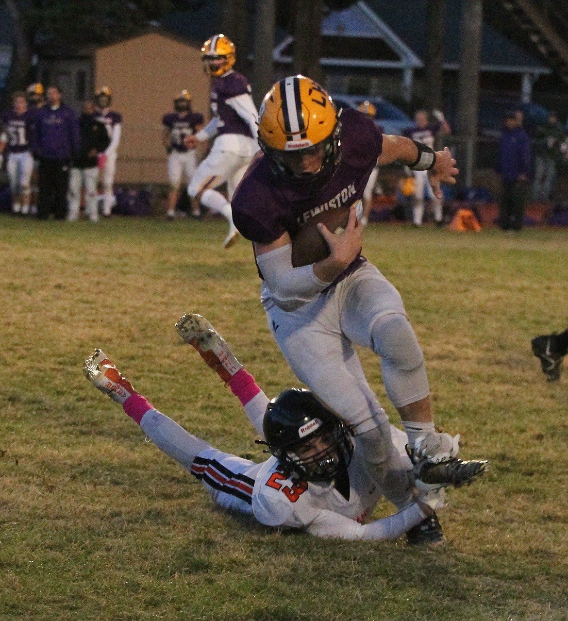 MARK NELKE/Press
Jack Sciortino (23) of Post Falls trips up Lewiston quarterback Jace McKarcher during a 5A Inland Empire League modified Kansas tiebreaker Monday night at Bear Field in Moscow.