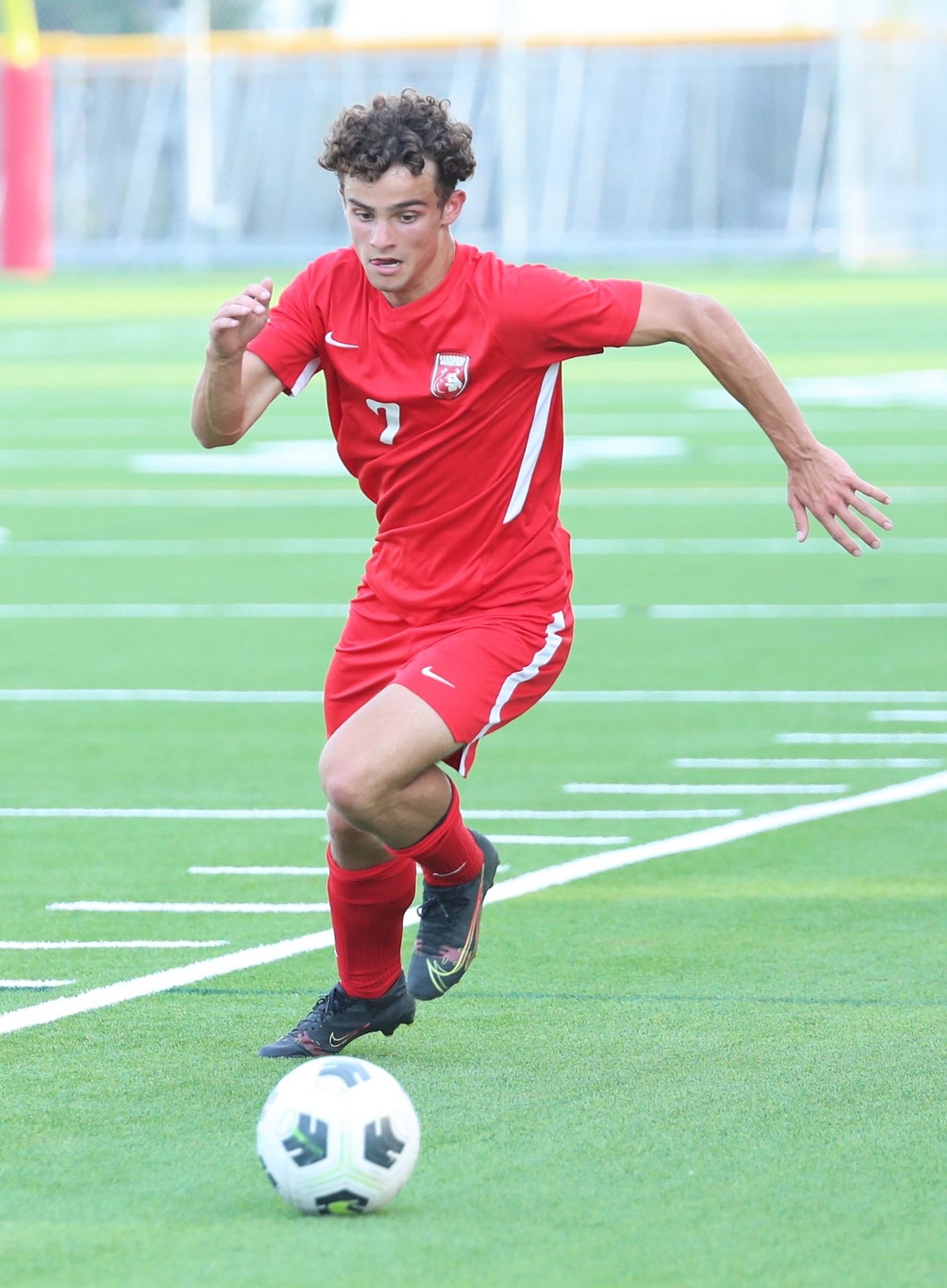 Senior Keyan Strock chases down a loose ball along the sideline during a match against Lakeland on Sept. 8.