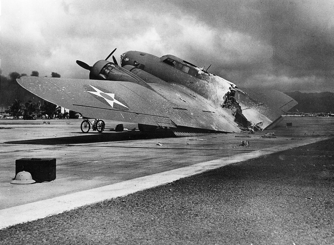 This B-17C Flying Fortress arrived at Hickam Field from California at the time of the Japanese attack on Pearl Harbor. It was hit during the approach and broke apart on landing, with crew members surviving — except a flight surgeon killed by strafing while fleeing the wreck (Dec. 7, 1941).