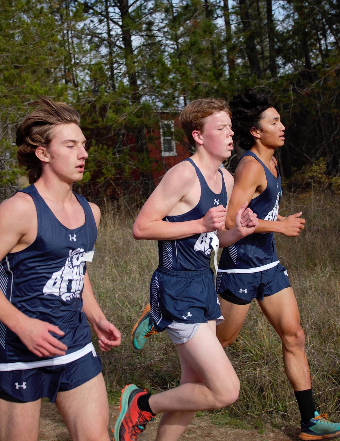 Collin Fairchild, Justin Strugar and Levi Bonnell running at the districts XC meet in Priest River.