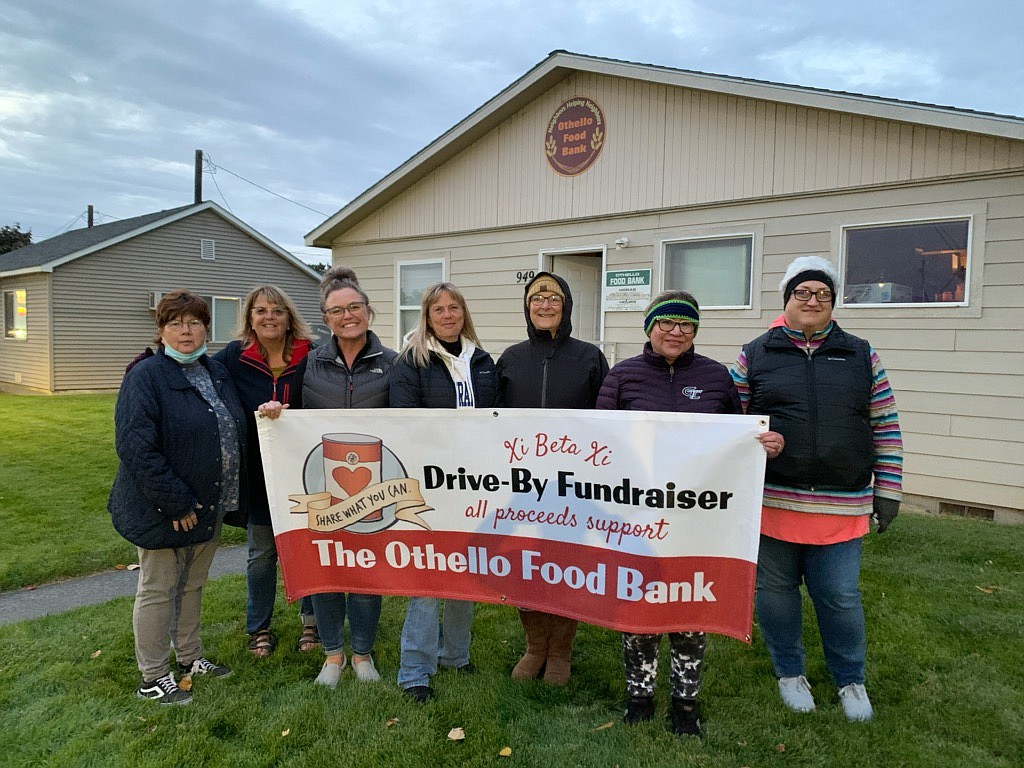 From left, Othello Food Bank director Shannon Mobley and Xi Beta Xi members Debbie Pegram, Kris Robertson, Linda Brady, Colette Simpson, Bianca Garcia and Liz Jensen stand outside the food bank during the Oct. 12 fundraiser.