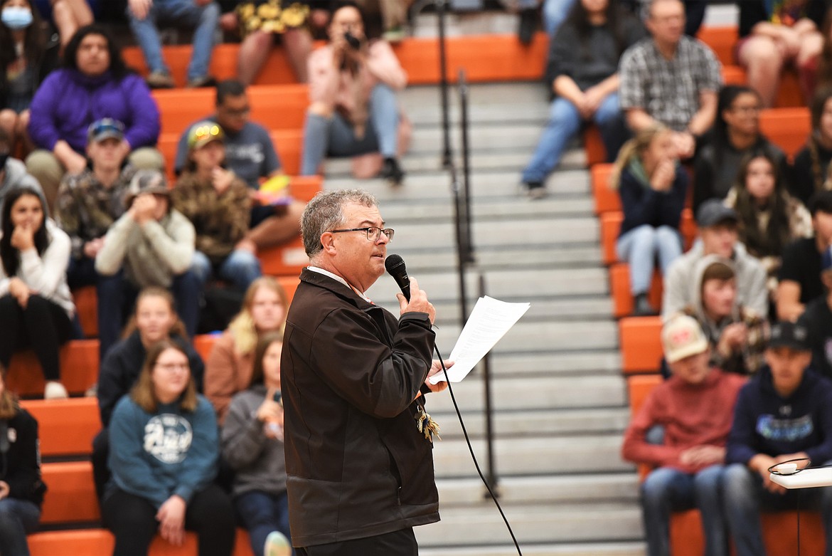 Ronan High School principal Kevin Kenelty addresses a full assembly of students Monday to announce some recent teaching awards. (Scot Heisel/Lake County Leader)