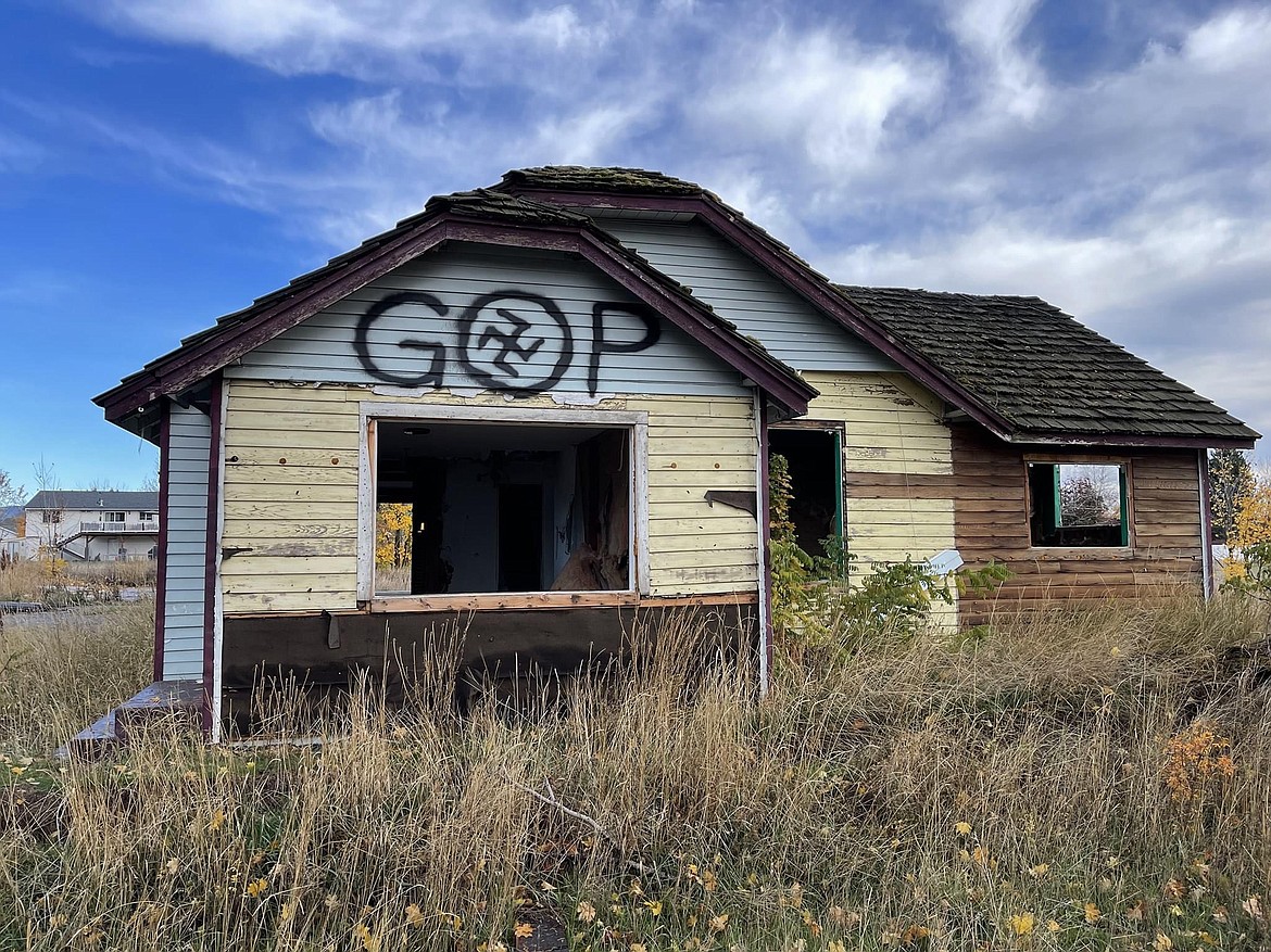 An abandoned house on Mullan Avenue was vandalized over the weekend with a black, backward swastika. Photo courtesy Post Falls Police Department.