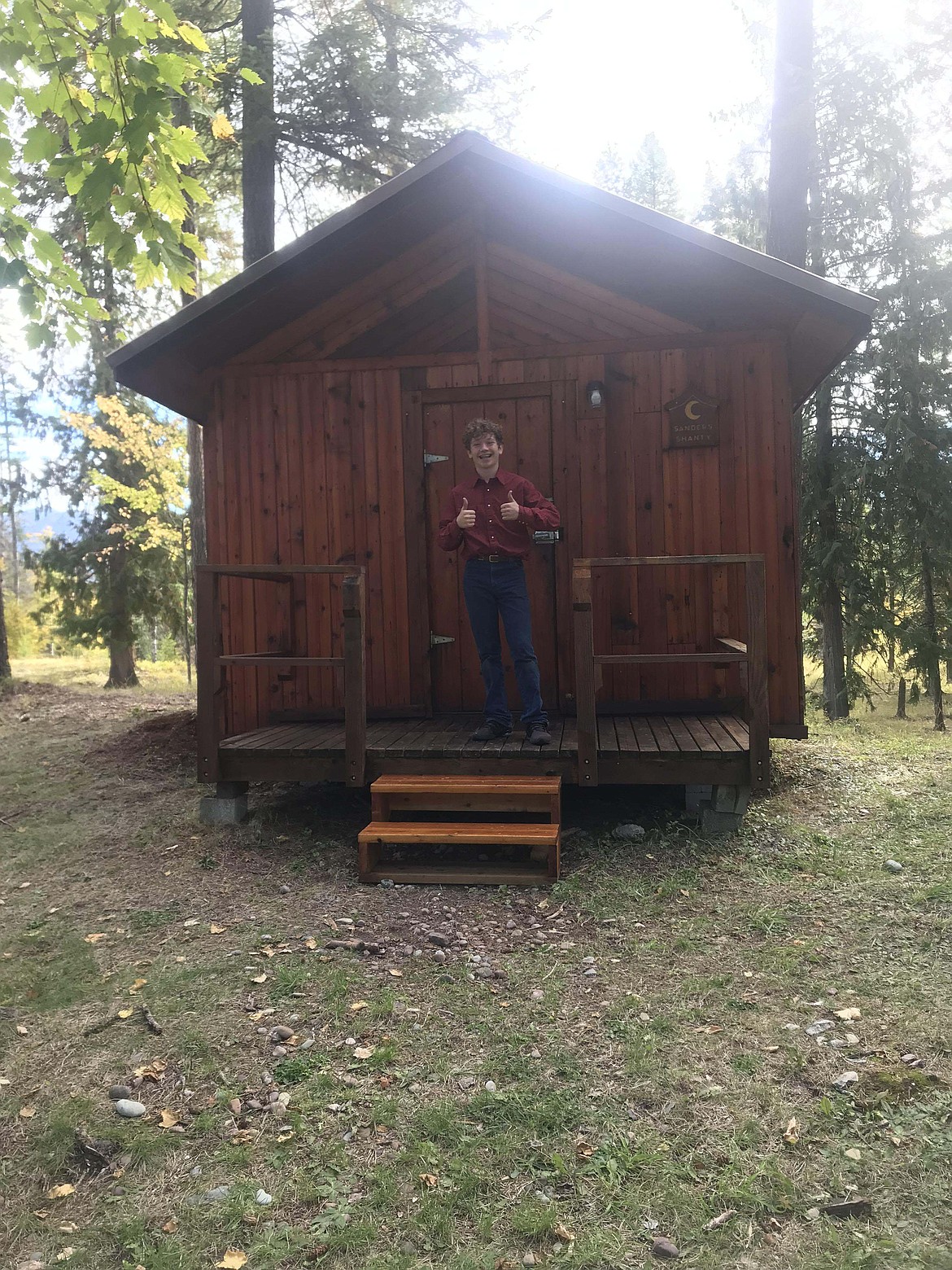 Korbin Baldwin in front of one of the 4-H cabins. (Courtesy photo)