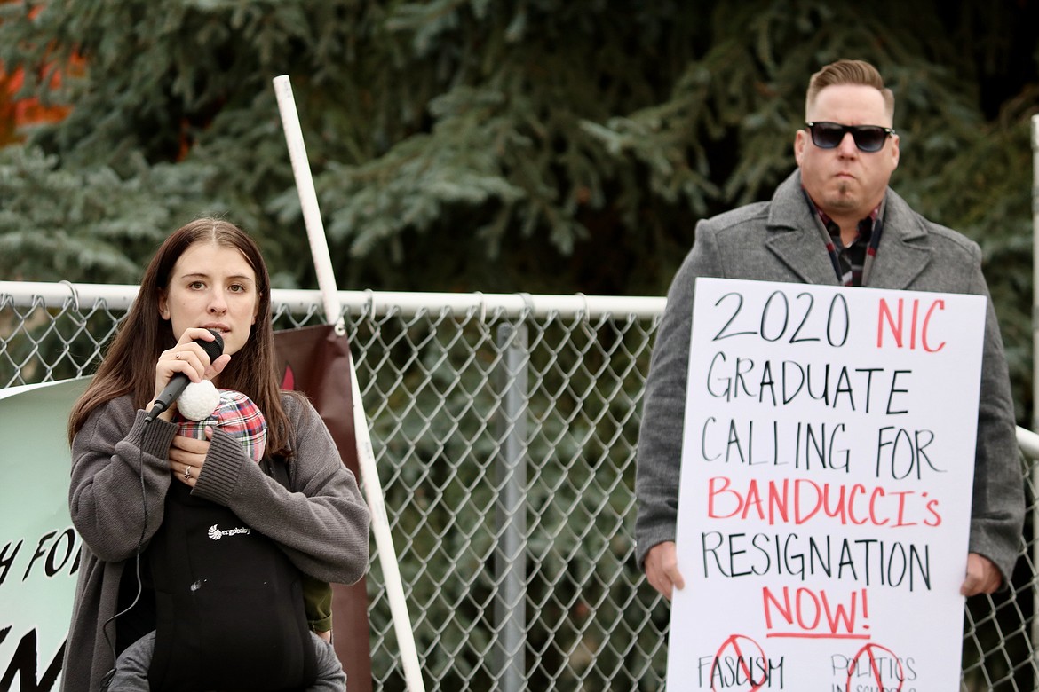 Ciara Platt, a 25-year-old NIC student and organizer of the March for MacLennan, opens the floor for speaking on the soccer field at North Idaho College on Wednesday prior to the Board of Trustees meeting. Shawn Keenan, a Coeur d’Alene native and NIC alumnus, stands to the right holding a sign for one of the protesters. HANNAH NEFF/Press