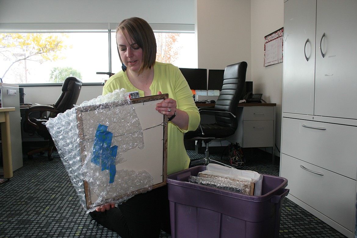 Angela Hunt unpacks artwork for her upcoming show at the Moses Lake Museum & Art Center, where her art will be on display beginning Nov. 5.