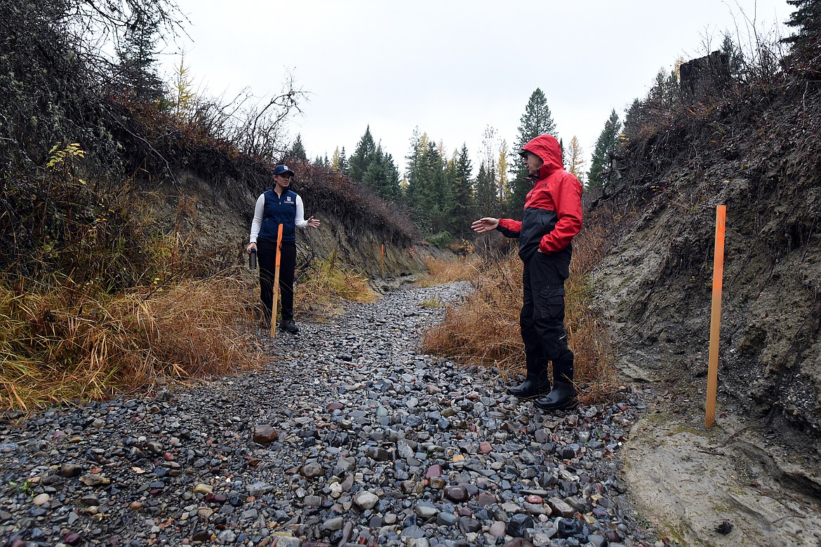 Landowner Don Garner, right, and Flathead Conservation District Resource Conservationist Hailey Graf stand in the bed of Krause Creek Monday, October 25 discussing project which aims to curtail the yearly erosion of the creek by springtime flooding. (Jeremy Weber/Daily Inter Lake)