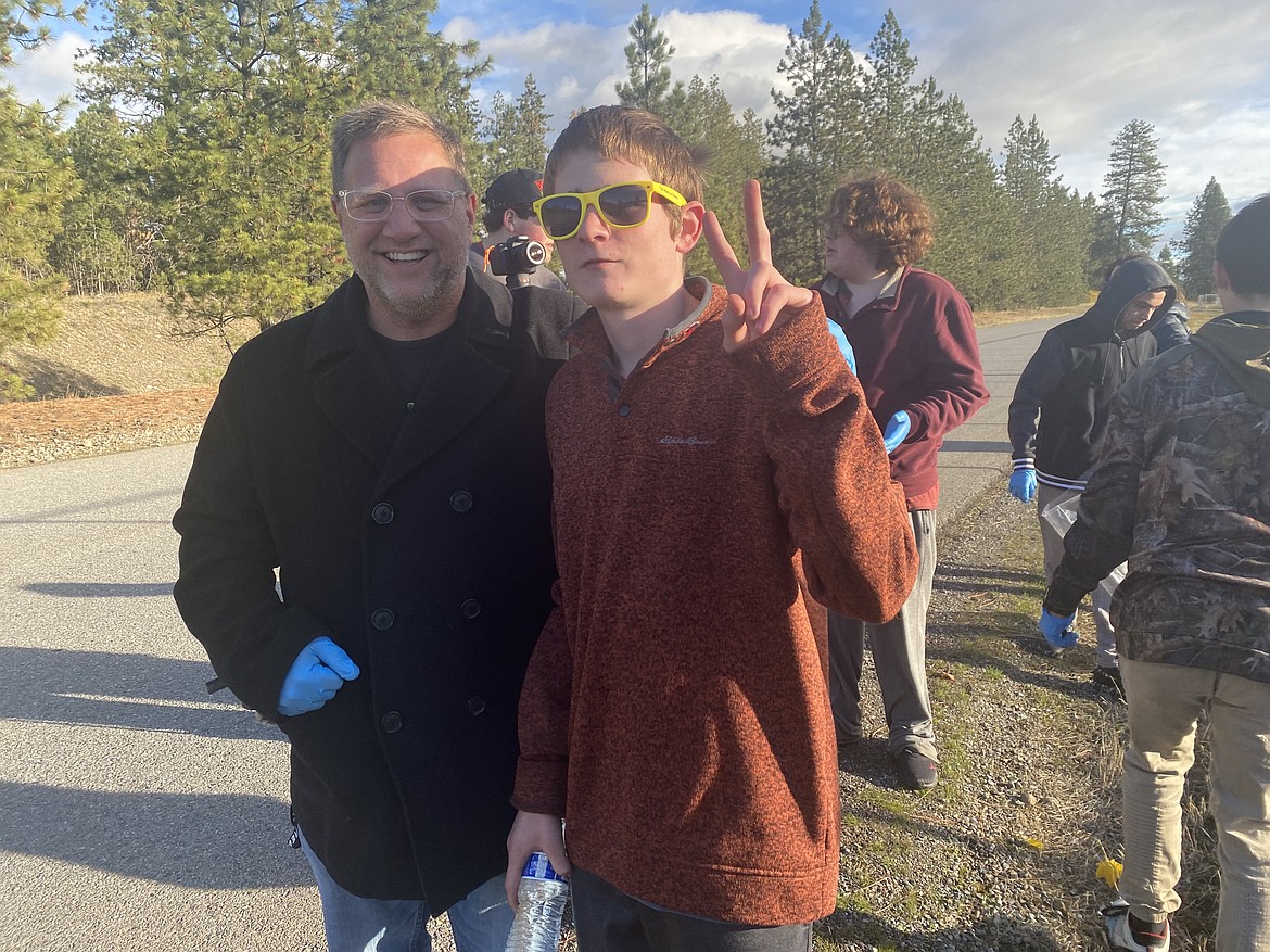 From left: Teacher Mark Gorton and student Adam Bosanko take a moment to clown around during a school wide effort to clean-up Main Street Wednesday.