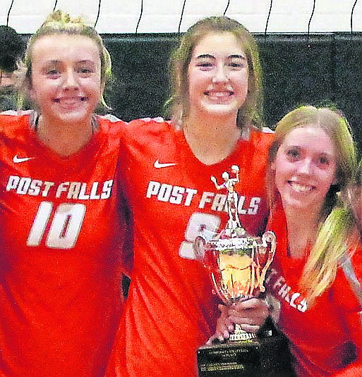 MARK NELKE/Press From left, Kylee Munday, Rylee Hartwig and Kassie Gardiner after Post Falls won the 5A Region 1 volleyball title last week at The Arena.