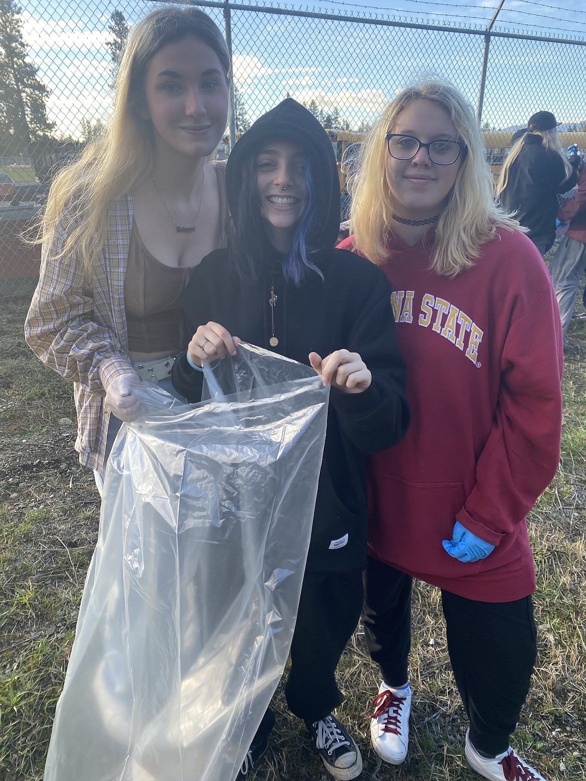 From left: Mountain View High School students Hannah Nunneley, Mackenzie Holder and Caitlyn Eliason collected rubbish along Main Street Wednesday.