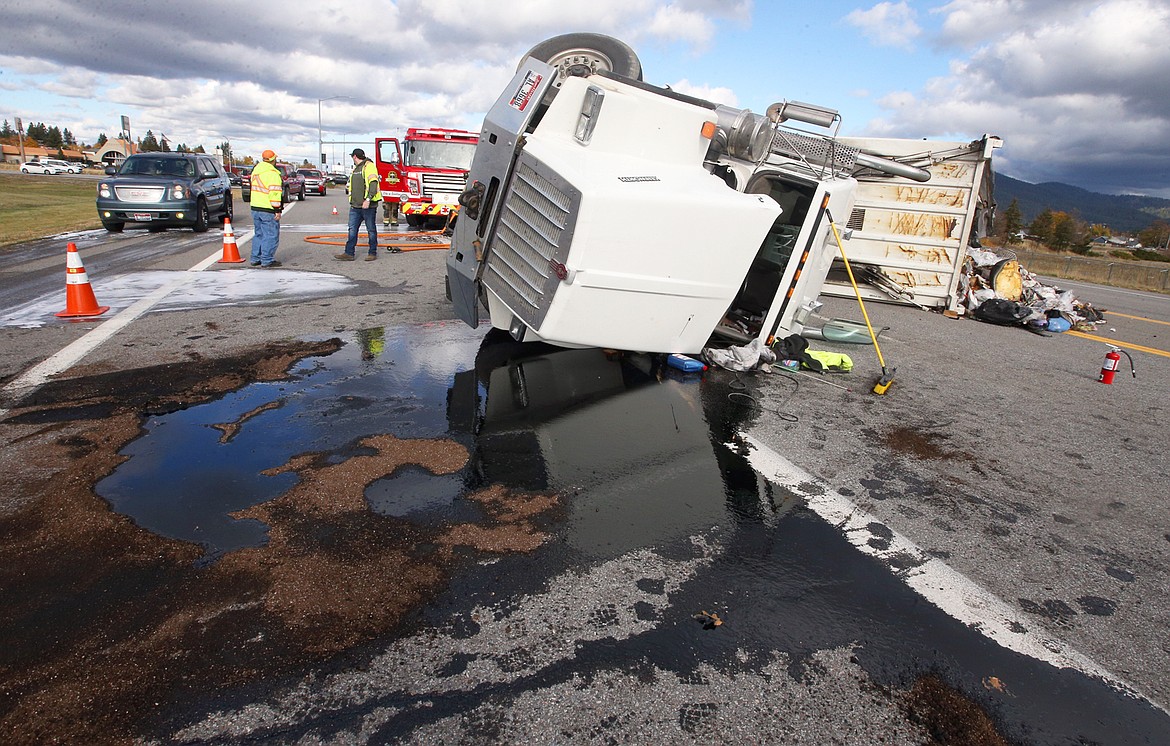 Oil leaks from a semi-trailer truck after it overturned on U.S. 95 just off Interstate 90 near Ironwood Drive on Wednesday.