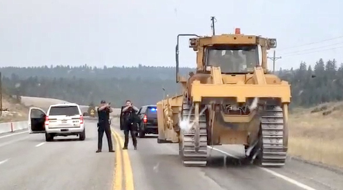 Law enforcement are pictured stopping Allen Funkhouser on Highway 95 after he was accused of driving a stolen D8-T Caterpillar on July 18.