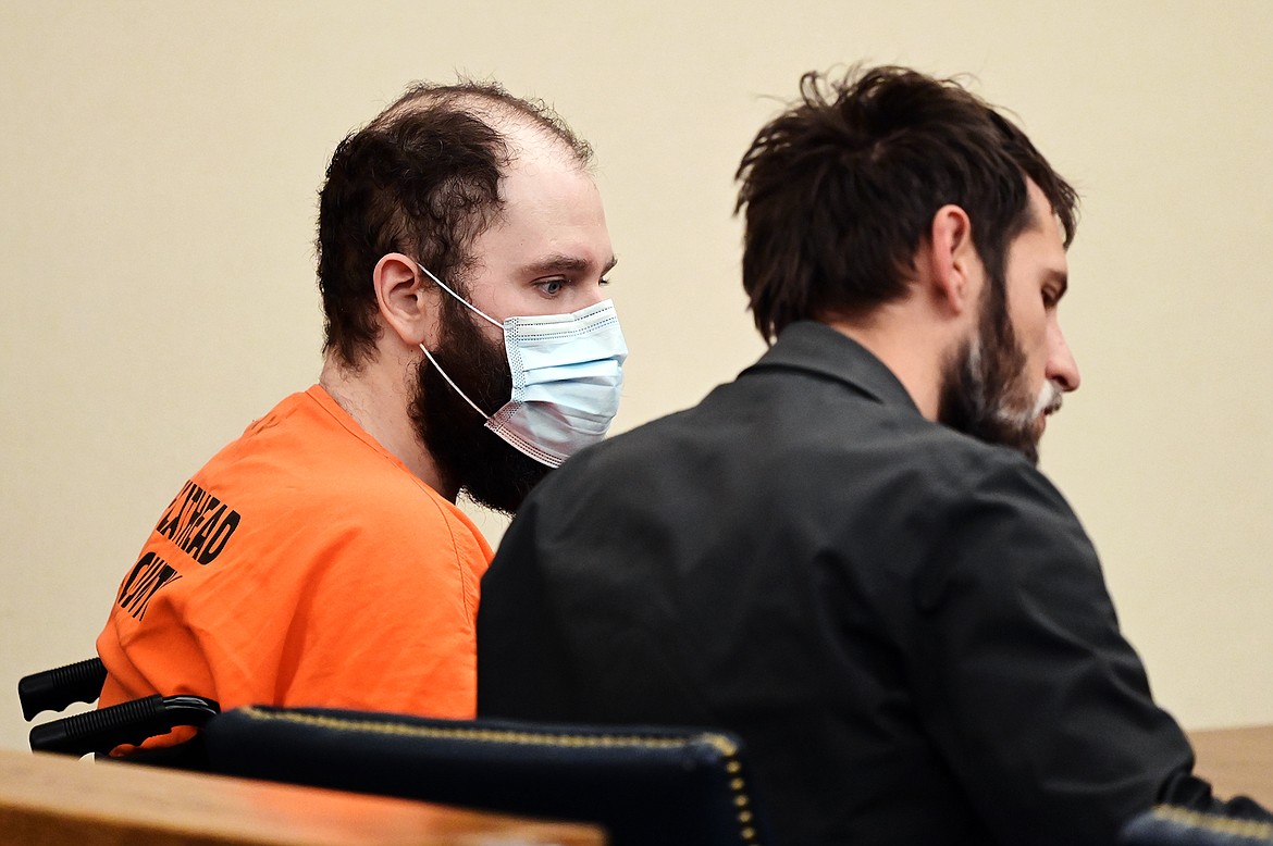 Jonathan Douglas Shaw speaks to his attorney at his arraignment in Flathead County District Court in Kalispell on Thursday, Oct. 28. (Casey Kreider/Daily Inter Lake)