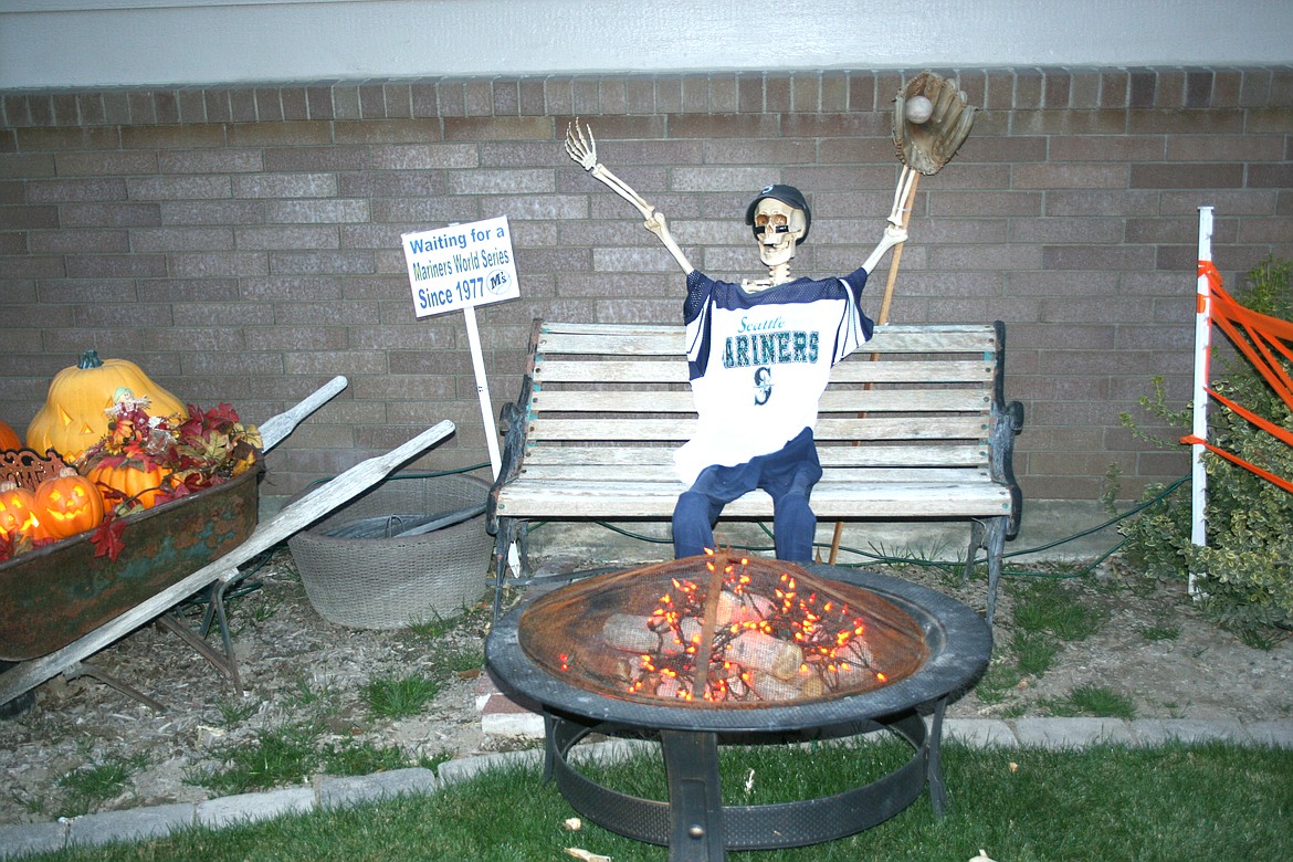 In a humorous scene, a diehard Mariners fan waits patiently for that World Series in the Halloween display at the Coulter home.