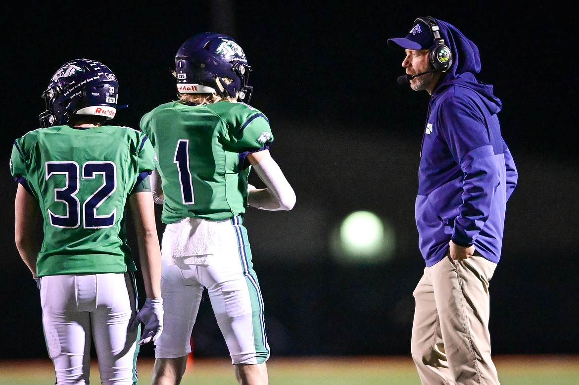 Glacier head coach Grady Bennett talks with wide receivers Tate Kauffman (1) and Jake Turner (32) in the first quarter against Billings Senior at Legends Stadium on Friday, Oct. 29. (Casey Kreider/Daily Inter Lake)
