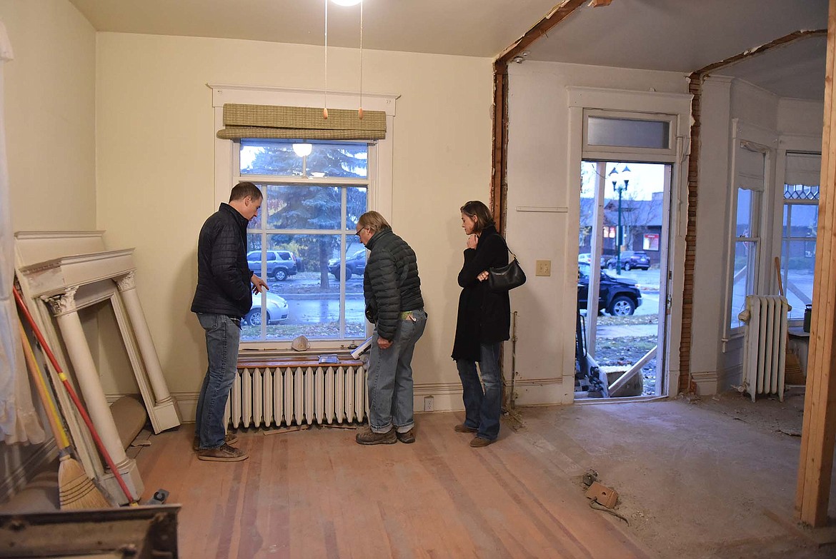 Andrew and Denise Strong discuss renovation plans with Leo Keane, center, inside the Houston home last week. (Heidi Desch/Whitefish Pilot)