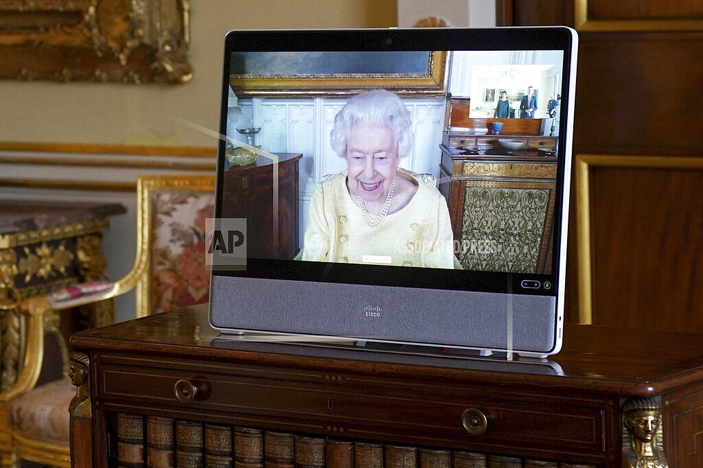 Queen Elizabeth II appears on a screen via videolink from Windsor Castle, where she is in residence, during a virtual audience at Buckingham Palace, London, Tuesday, Oct. 26, 2021. (Victoria Jones/Pool via AP)